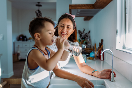 kid drinking clear water